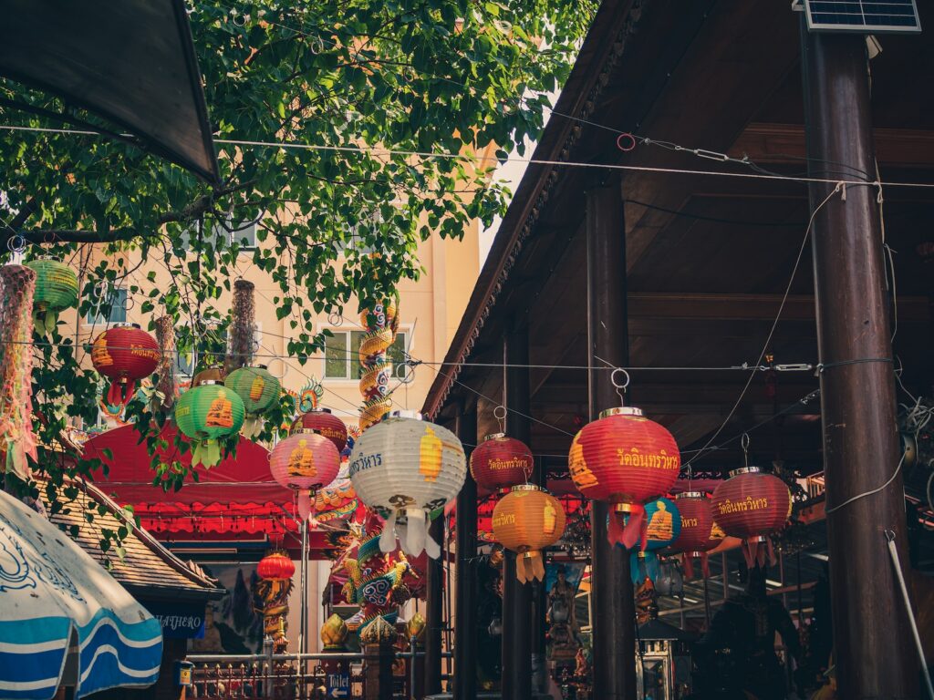 red and yellow paper lanterns hanged on brown wooden post